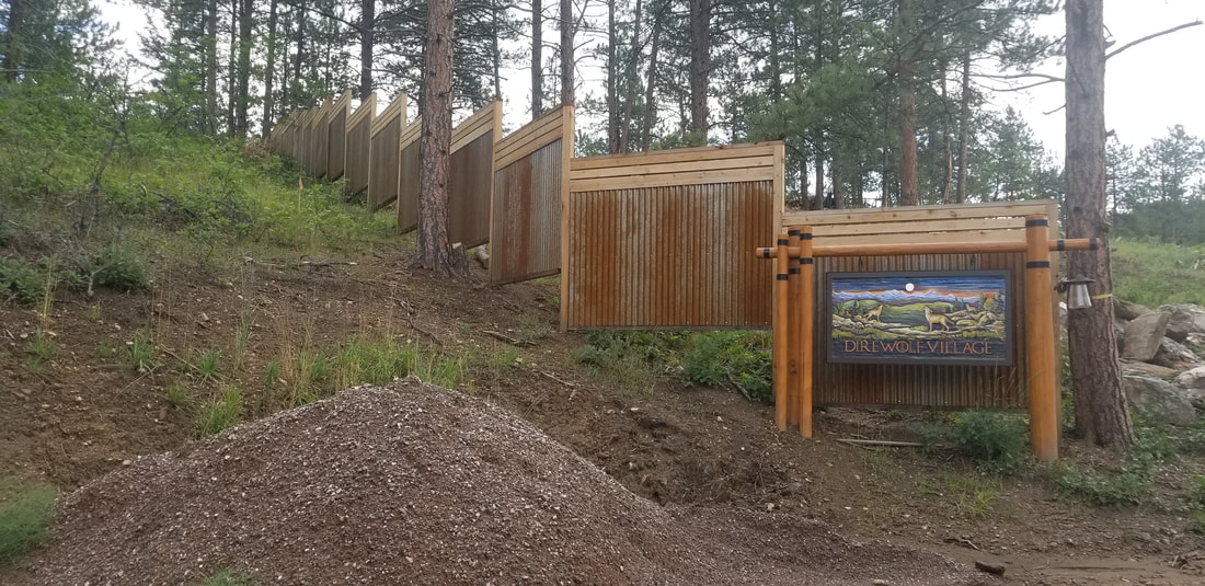 Picture of a custom stepped rusted steel and cedar perimeter fence built by The Montross Brothers in Jefferson County, Colorado